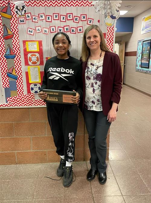 Ronda Anderson, McKinley's Stairclimber for May 2023, poses with her plaque and Assistant Principal Jackie Bull.